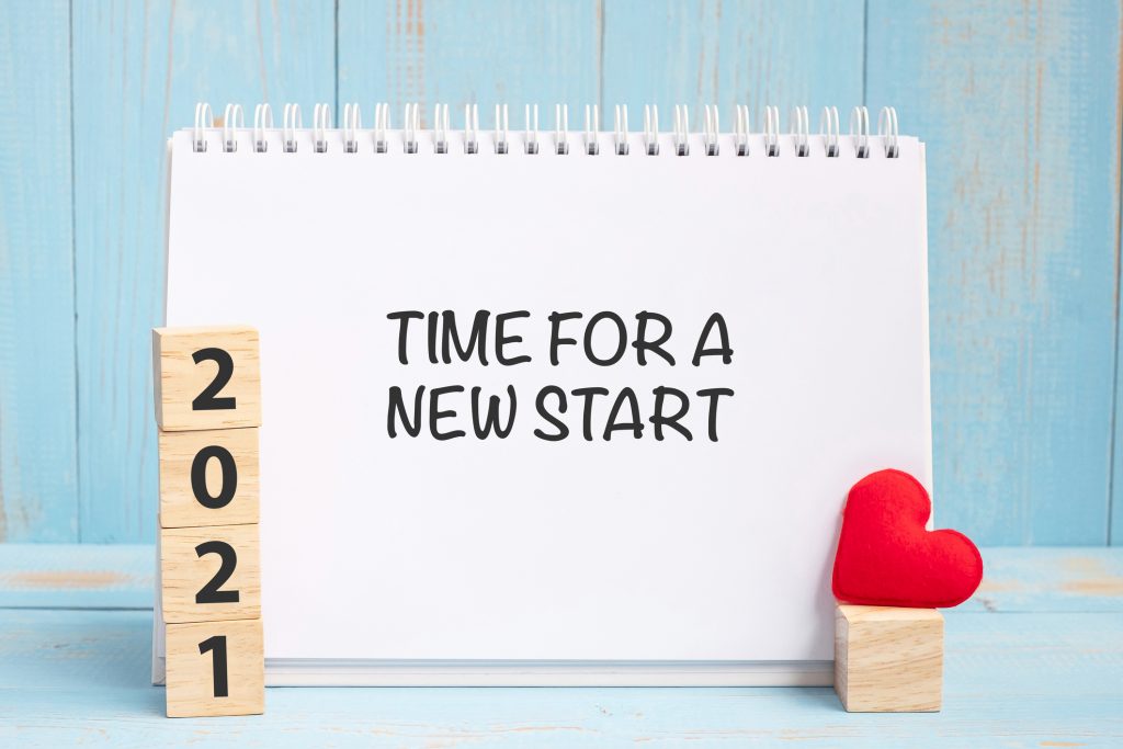 Image of blocks with 2021 printed on them with a heart and a note saying "Time for a new start."