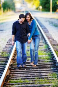 couple-walking-on-railroad-tracks-image