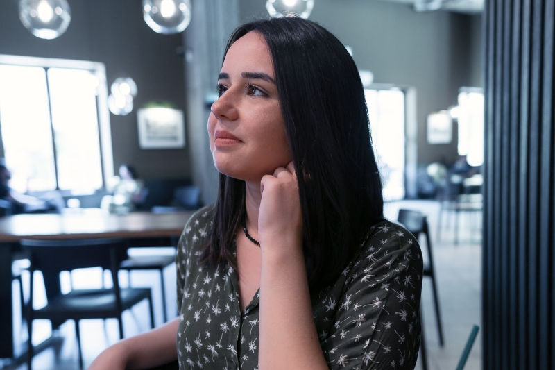 Woman sitting by herself wondering, "Will I ever meet someone?"