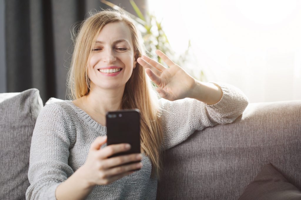 Woman having a video date because she's learned how to make social distancing and dating work.