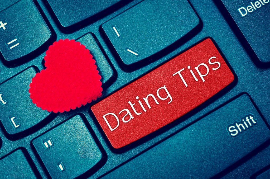 Computer keyboard with "Dating Tips" covering the enter key.