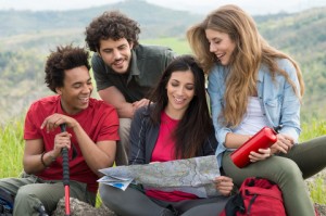 Group of friends looking at a map to find places to meet singles