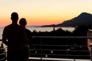 Happy couple who met because he followed this dating advice for widowers looking out over the ocean.