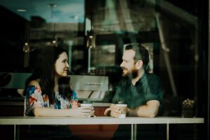 Couple have fun dating over 50 at a coffee shop.