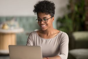 Woman searching online for a certified professional life coach.