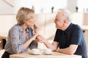 A couple answering relationship-building questions over coffee.