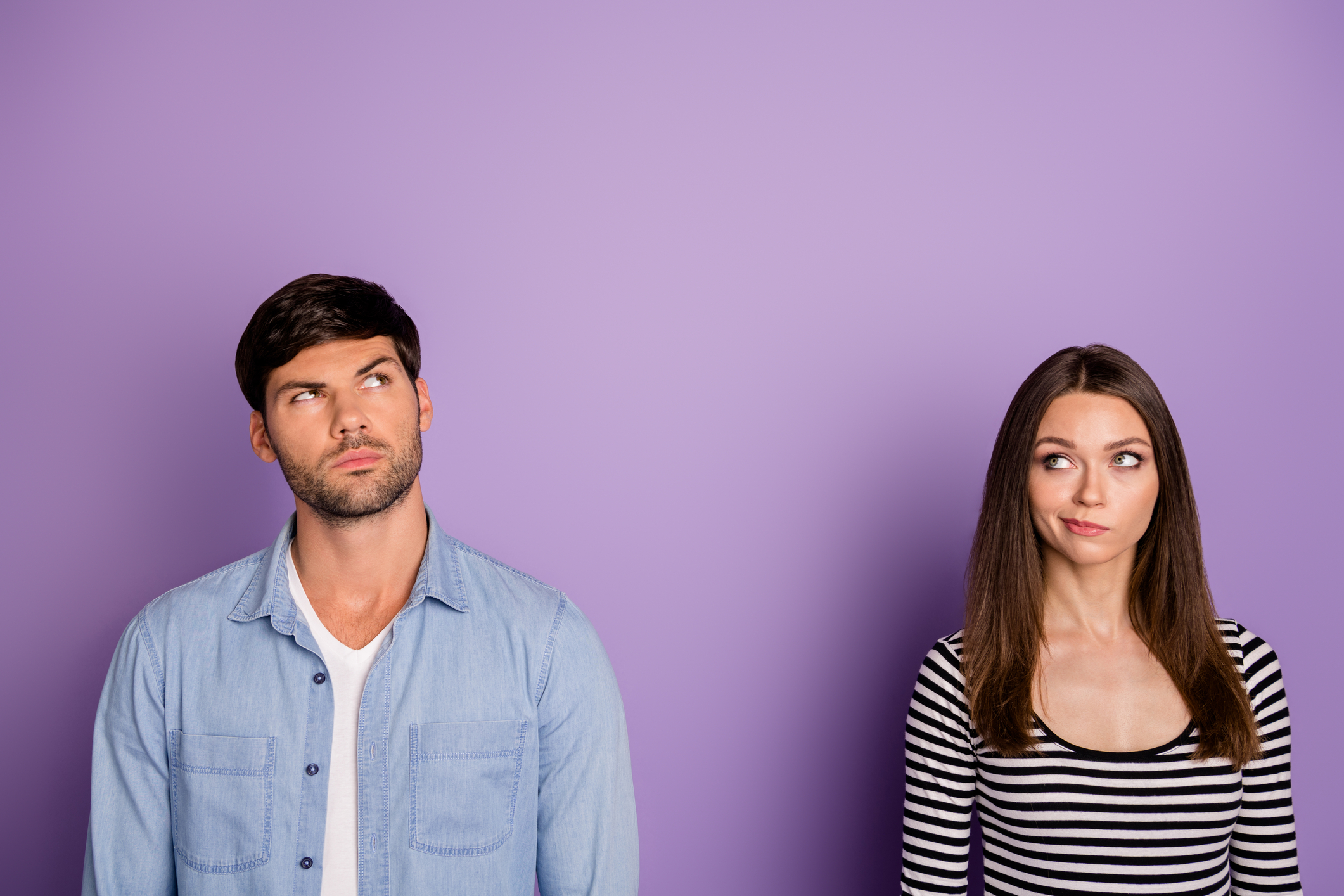 Couple standing together yet apart wondering about true love vs fake love