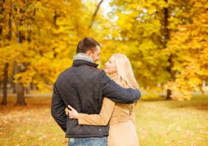 Couple standing in a forest basking in their love for each other.