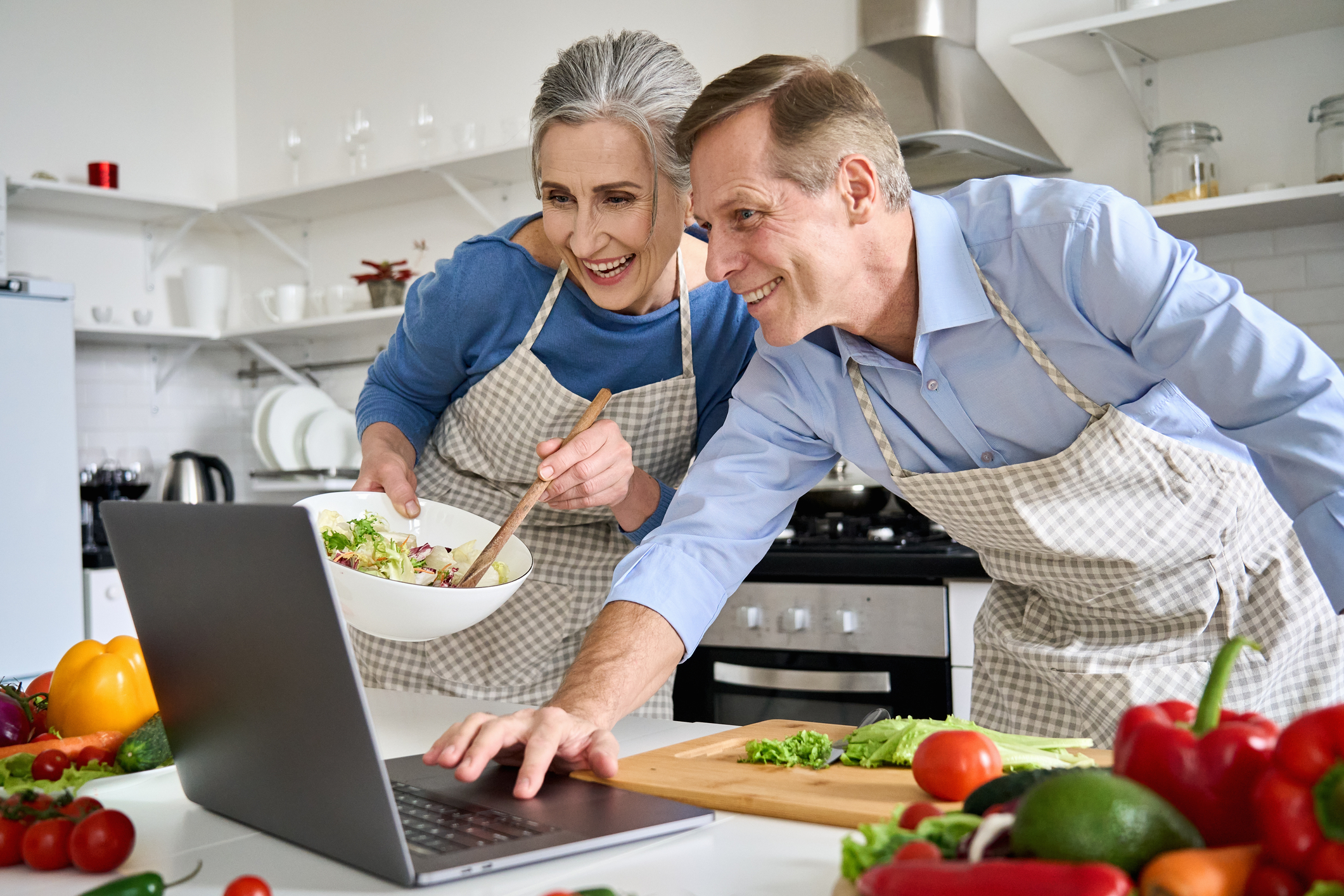 Couple who knows how to make their love last in relationship cooking a new recipe together.