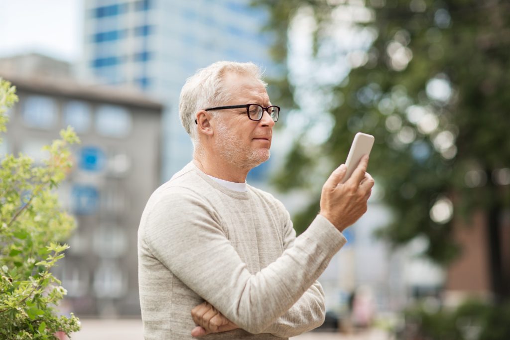 Man looking at his latest online dating chat and wondering if it's time to ask for a date.