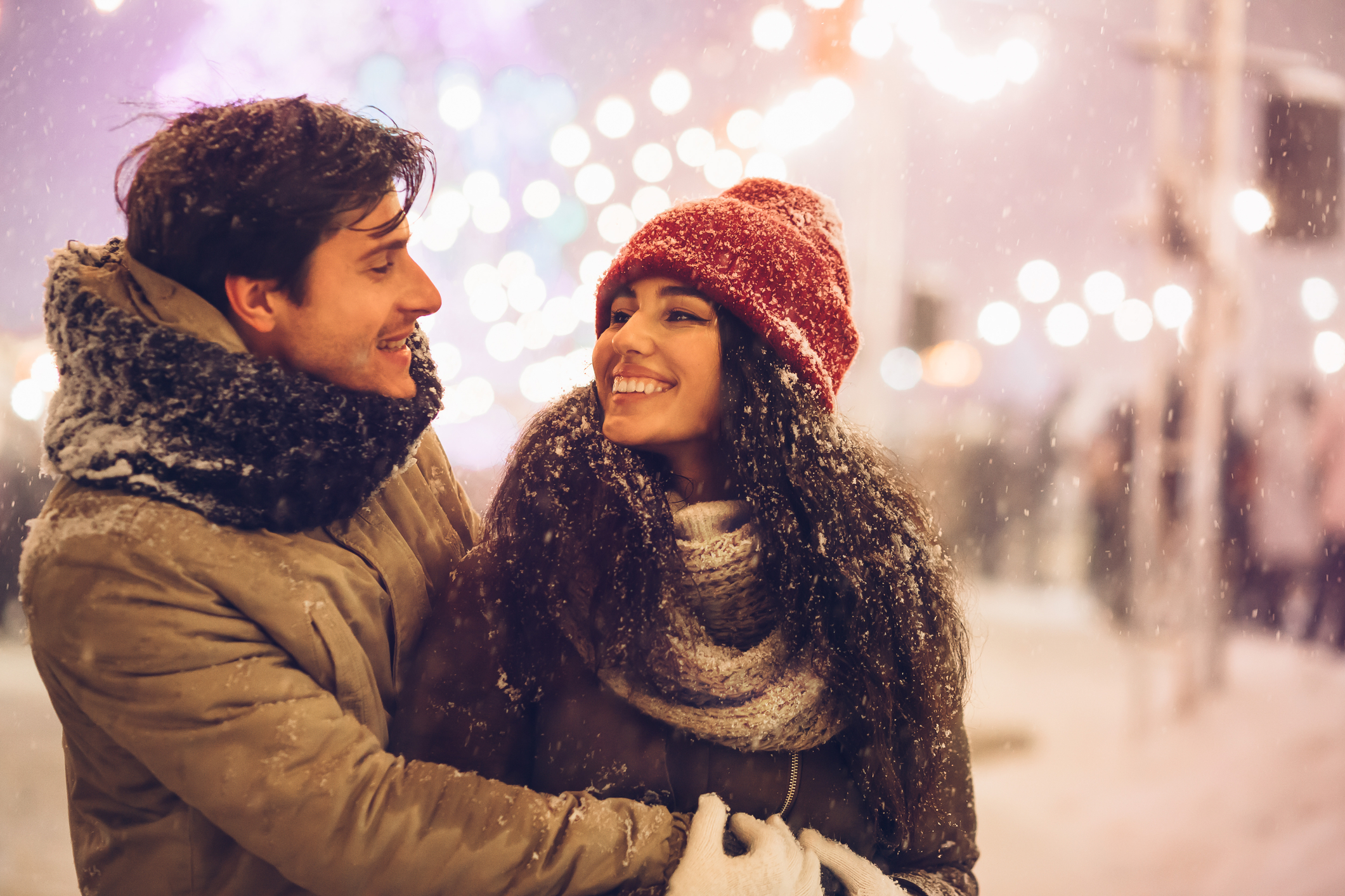 Couple at a winter celebration smiling at each other and basking in the joy of finding love again