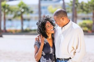 A happy couple embracing on the beach who understood how to keep an open mind when looking for love.