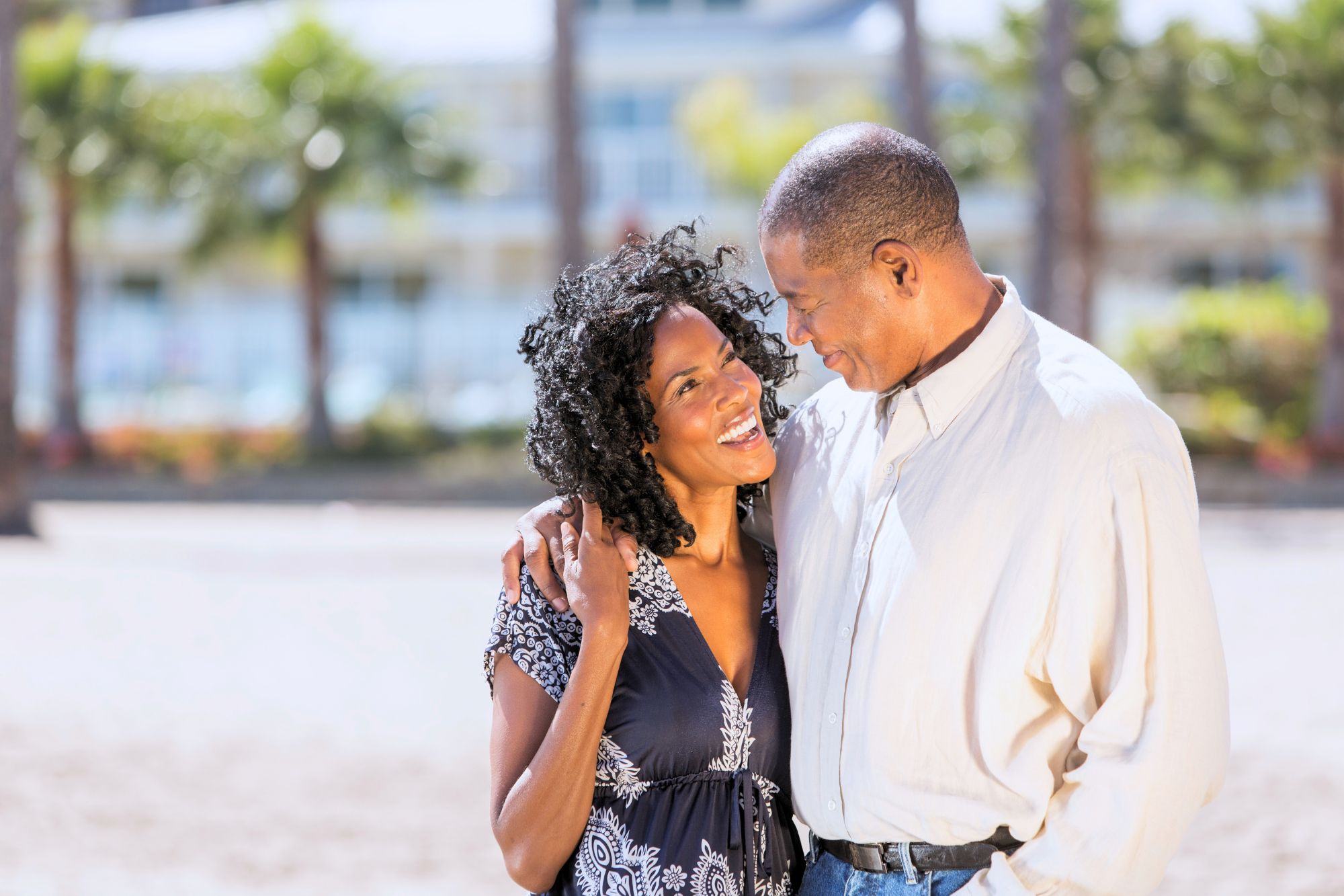 A happy couple embracing on the beach who understood how to keep an open mind when looking for love.