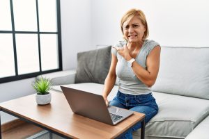 Woman crigning while looking at an online dating profile that doesn't work!