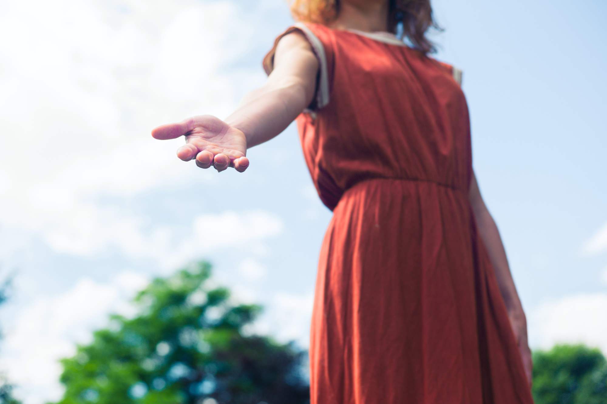 kindness-is-an-attractive-trait A woman reaching down to help someone showing that kindness is an attractive trait.