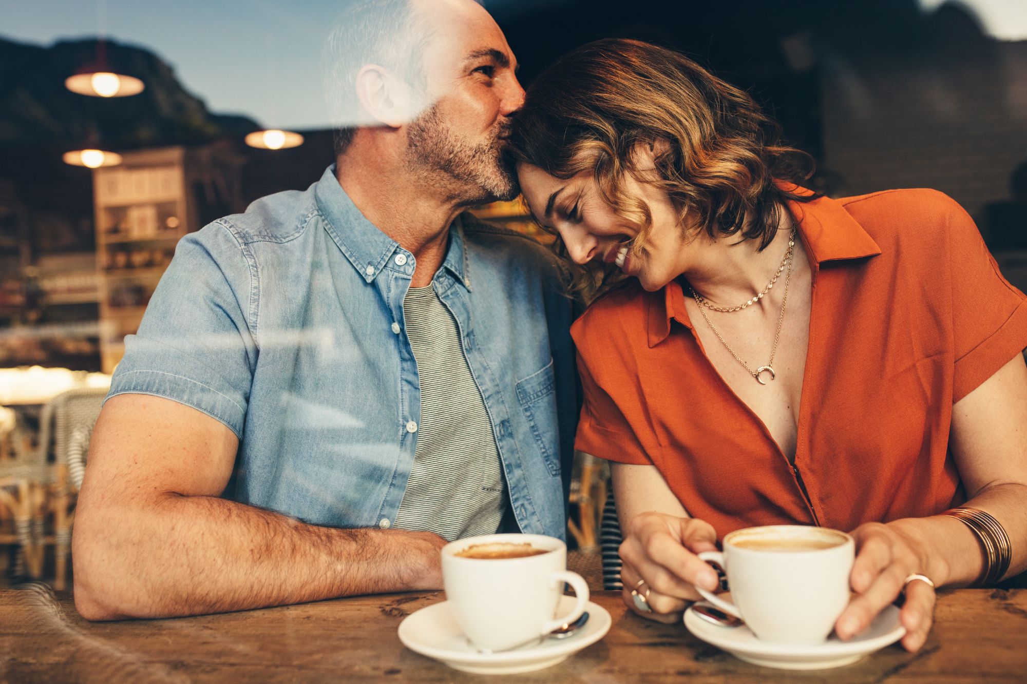 A couple who has learned how to be romantic, on a date in a cafe.