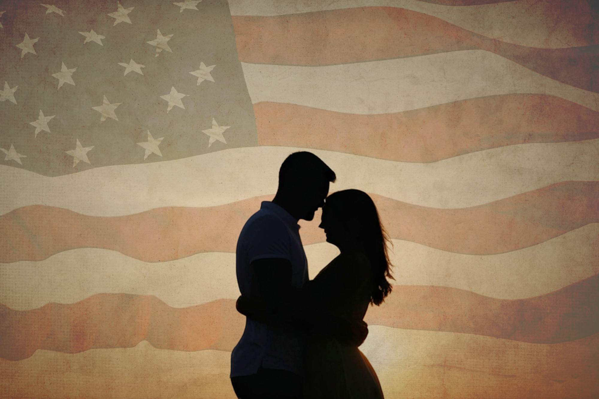 what-250-years-of-independence-can-teach-singles-about-finding-love Silhouette of a couple in love in front of a faded American flag celebrating Independence Day.